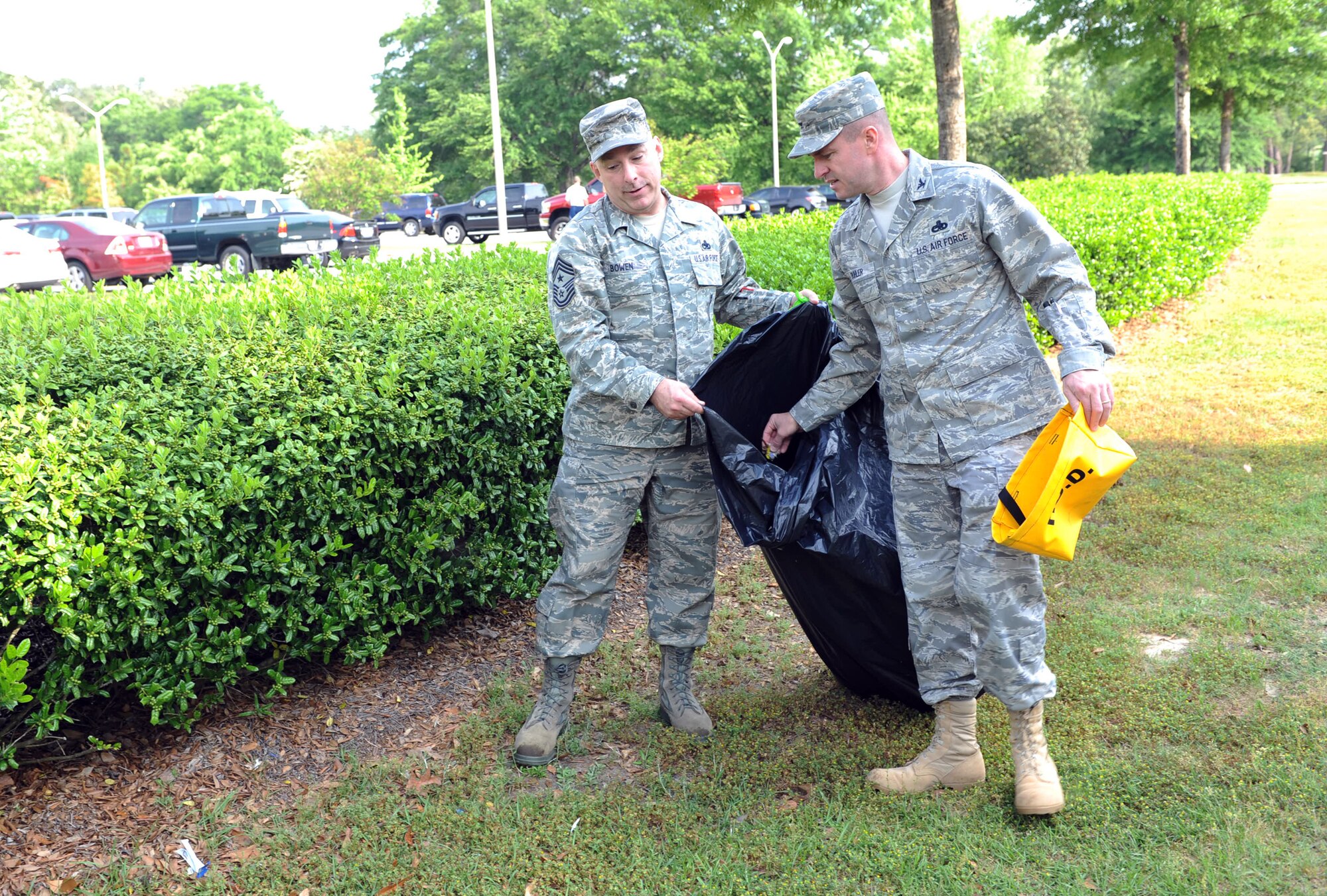 Col. Carl Buhler, 78th Air Base Wing commander, and Chief Master Sgt. Patrick Bowen, Installation Command Chief, collect trash April 15 as part of the Base Clean-up. U. S. Air Force photo by Raymond Crayton Jr.   