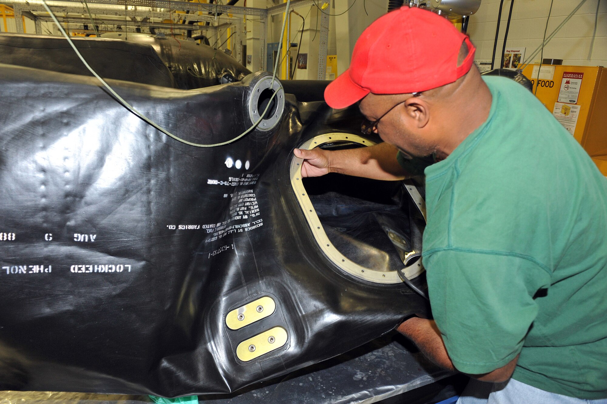 Lyndon Baines Johnson, 402nd Commodities Maintenance Group Fuel Cell Repair Shop mechanic, inspects a fuel cell bladder. U. S. Air Force photo by Tommie Horton