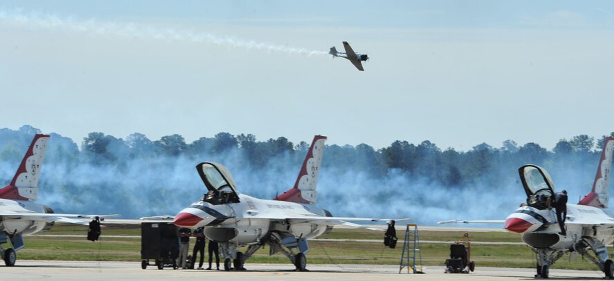 SEYMOUR JOHNSON AIR FORCE BASE, N.C. -- Tora! Tora! Tora! aircraft fly over parked U.S. Air Force Thunderbirds jets during the Wings Over Wayne Air Show and Open House here, April 17, 2011. Tora! Tora! Tora! participates in 12 to 16 events a year recreating the Japanese attack on Pearl Harbor that began the American involvement in World War II.  (U.S. Air Force photo/Senior Airman Whitney Lambert) (RELEASED)