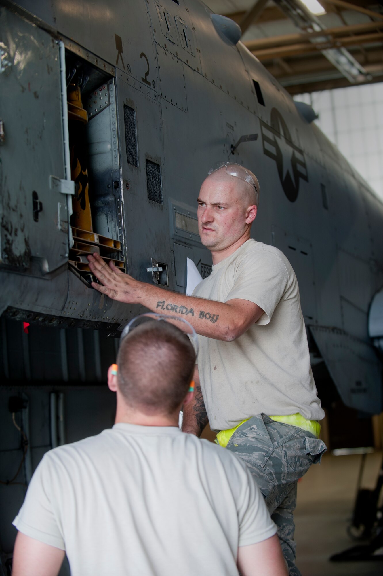 Staff Sgt. Jonathan Shipp, 23rd Equipment Maintenance Squadron aircraft structural maintenance craftsman, and Airman 1st Class Connor Minto, 23rd EMS aircraft structural maintenance apprentice, remove the remaining panels from an A-10C Thunderbolt II to replace a gun bay bracket at Moody Air Force Base, Ga., April 20. The bracket needed to be replaced because of small cracks that formed while maneuvering during flight. (U.S. Air Force photo/Airman 1st Class Douglas Ellis)(RELEASED)
