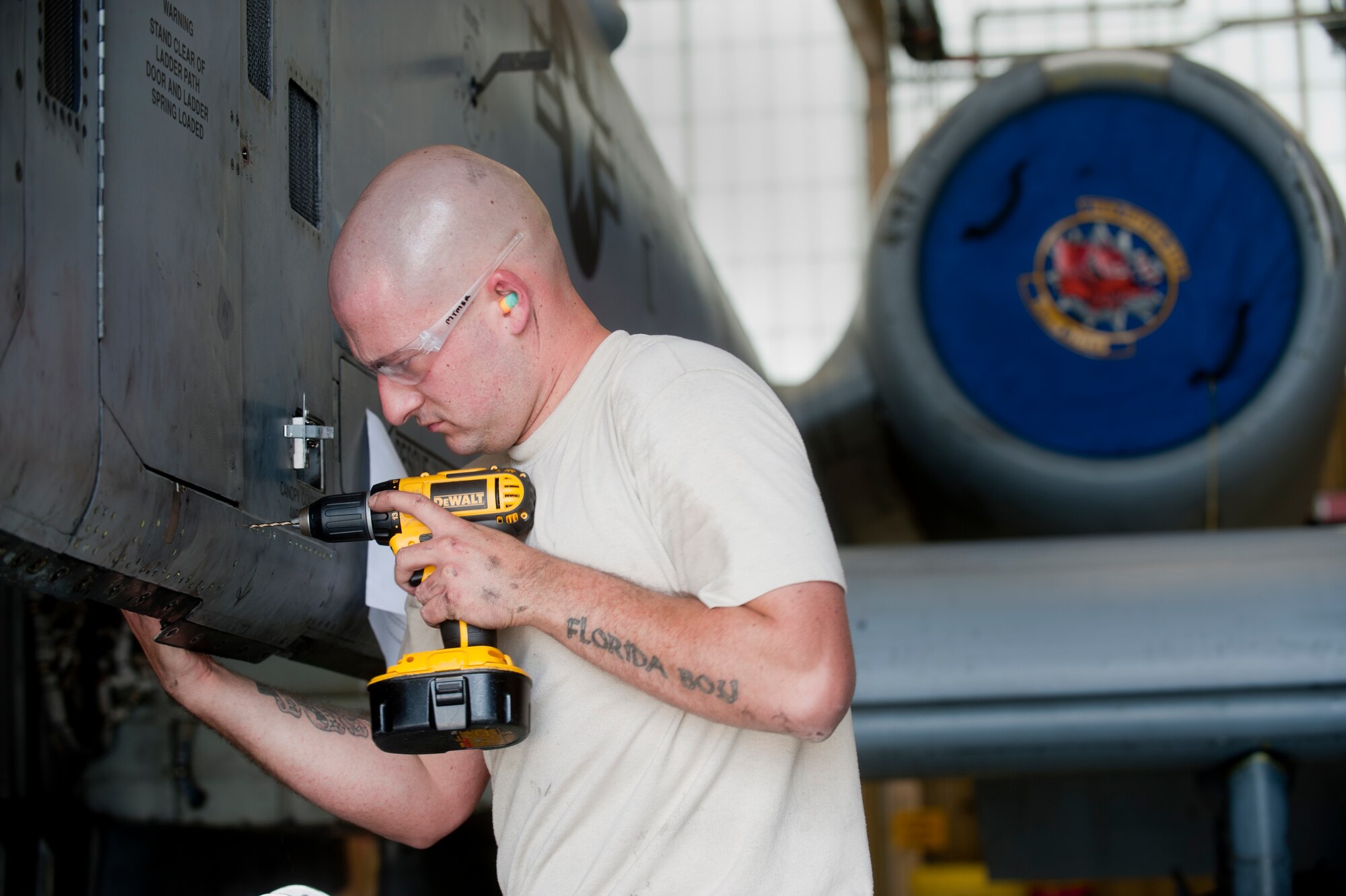Staff Sgt. Jonathan Shipp, 23rd Equipment Maintenance Squadron aircraft structural maintenance craftsman, drills into a panel on an A-10C Thunderbolt II at Moody Air Force Base, Ga., April 20. Drilling into the panel loosened the rivets and enabled him to replace the cracked bracket. (U.S. Air Force photo/Airman 1st Class Douglas Ellis)(RELEASED)
