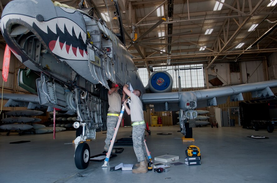 Staff Sgt. Jonathan Shipp, 23rd Equipment Maintenance Squadron aircraft structural maintenance craftsman, and Airman 1st Class Connor Minto, 23rd EMS aircraft structural maintenance apprentice, remove panels from an A-10C Thunderbolt II at Moody Air Force Base, Ga., April 20. The purpose of removing the panels was to replace the gun bay bracket. (U.S. Air Force photo/Airman 1st Class Douglas Ellis)(RELEASED)
