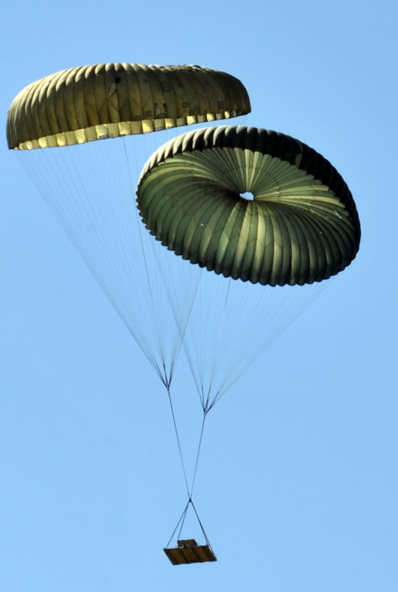 Cargo falls over the Black Jack drop zone April 13, 2011, north of Little Rock Air Force Base, Ark., during the combat surge week. The purpose of the surge week was to make up for lost flying time by increasing the operations tempo. (U.S. Air Force photo by Airman 1st Class Rusty Frank)