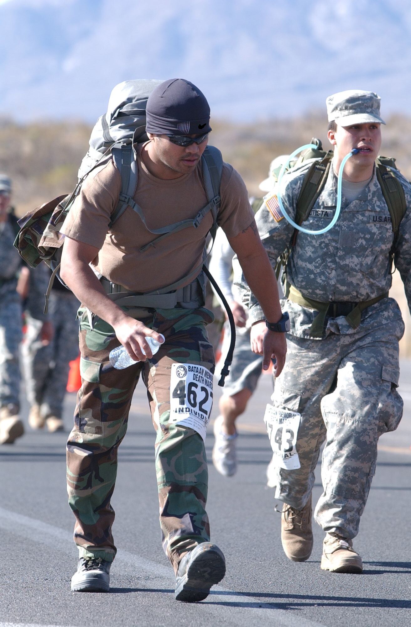 Sergeant Bautista, left, tackles Mile 13, one of the many difficult ascents on the course
conquered. He and the ROTC member on the right, also named Bautista, chatted and
kept each other company for a mile or two.  (Courtesy photo)