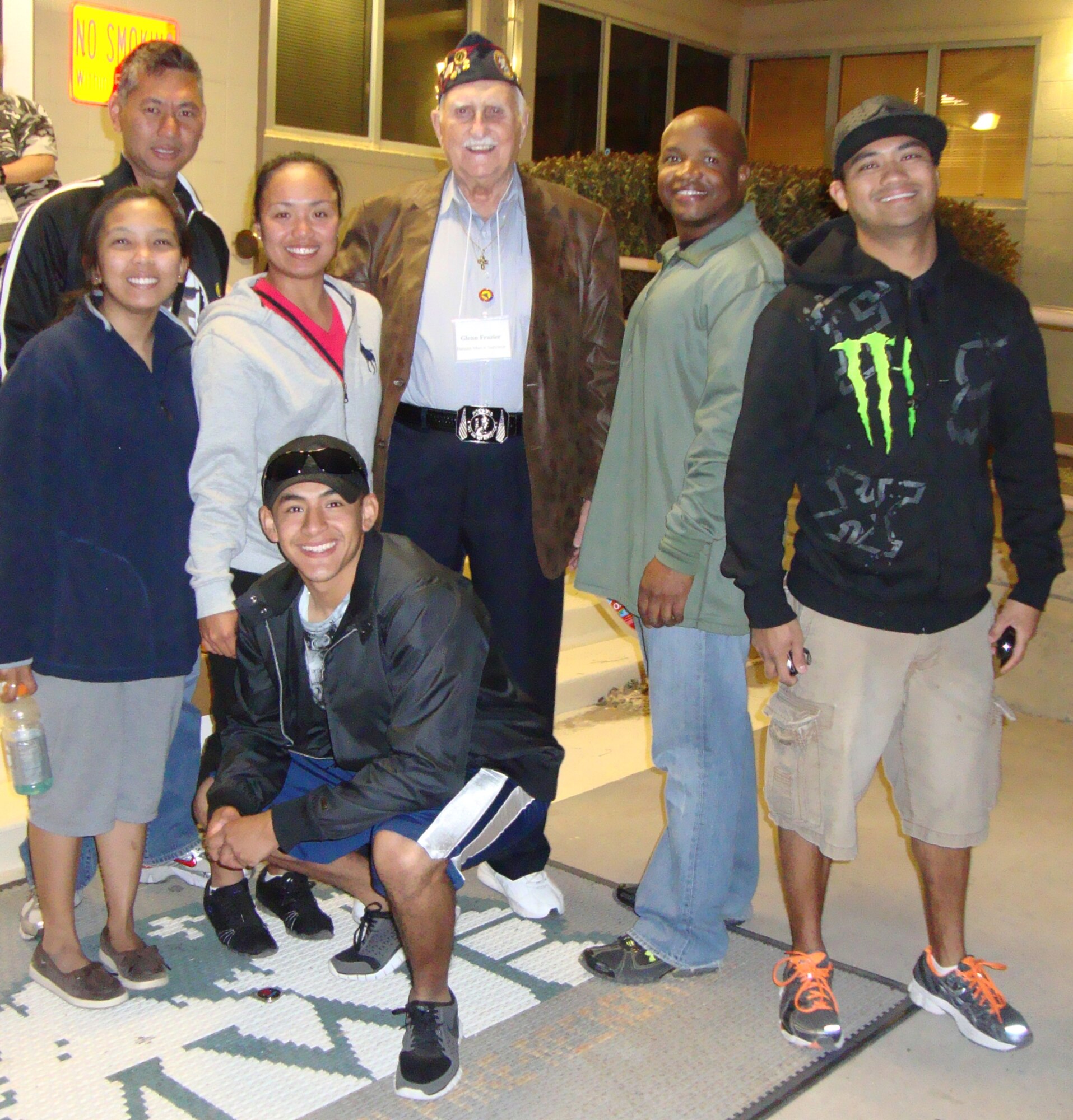 Six Keesler team members are shown with Bataan Death March survivor Col.
Glenn Frazier, center. They are Airman Hernandez (kneeling) and, from left,
Sergeant Villaflores, Mr.Viniegra and Sergeants Bittig, Smith and Bautista.  (Courtesy photo)