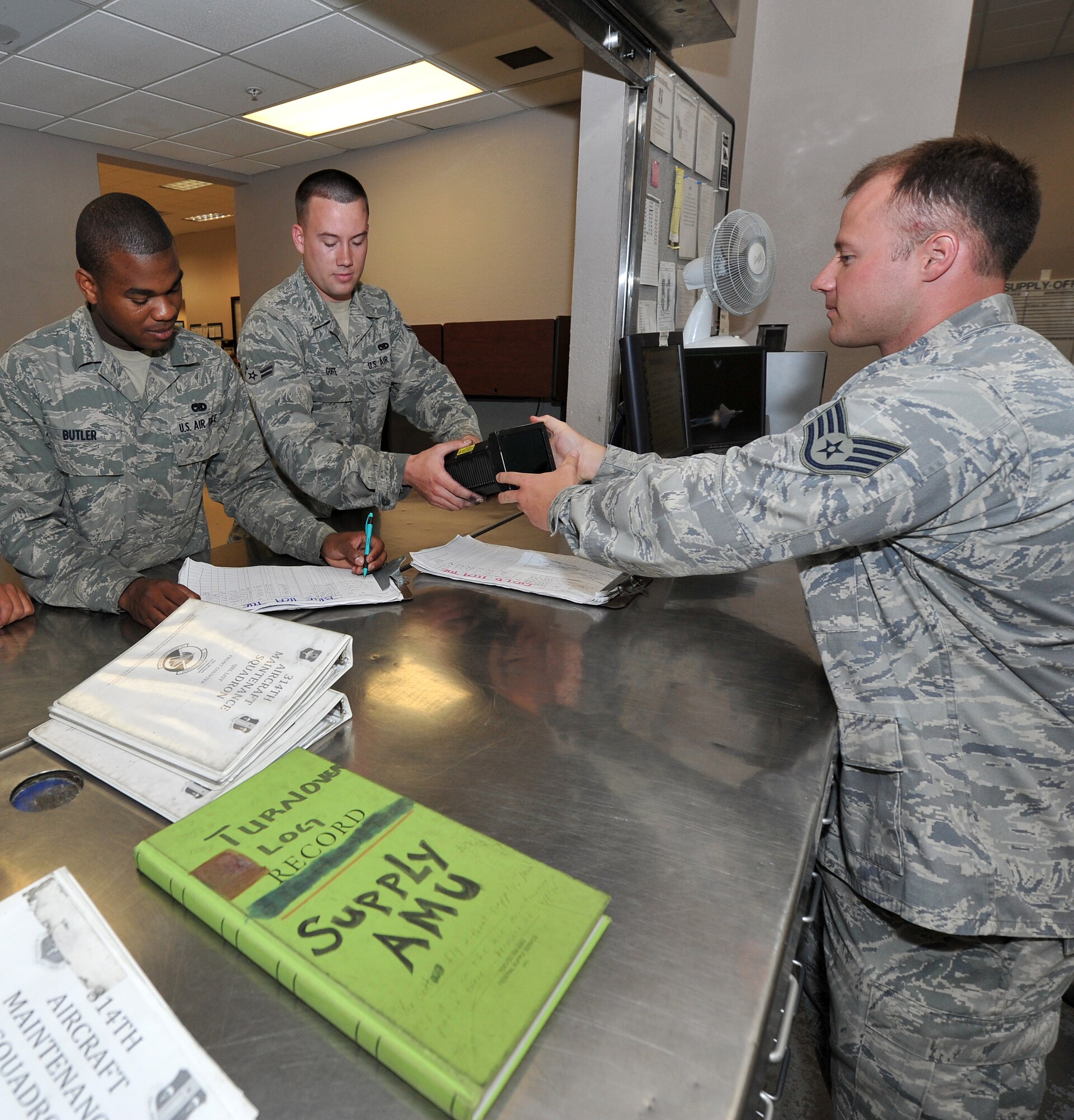 Airman 1st Class Tyler Butler (left) and Airman 1st Class James Goffe, both 314th Aircraft Maintenance Squadron crew chiefs, check out a C-130 display panel from Staff Sgt.  Zachary Replogle, a 314th Aircraft Maintenance Squadron supply sergeant, April 19, 2011, at Little Rock Air Force Base, Ark. (U.S. Air Force photo by Staff Sgt. Chris Willis)