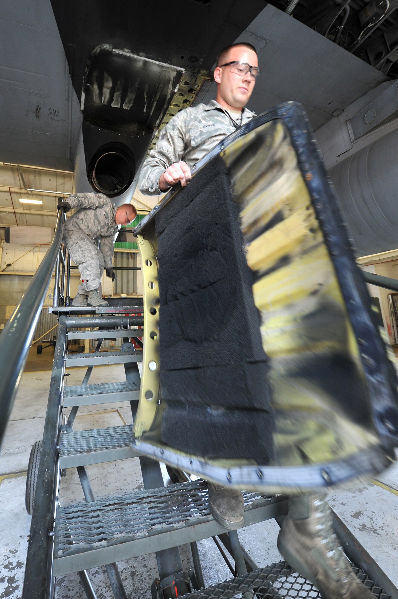 Senior Airman Dustin Woods (background) and Airman 1st Class James Goffe, both 314th Aircraft Maintenance Squadron crew chiefs, replace a heat shield on the wing of a C-130 E-model April 19, 2011, at Little Rock Air Force Base, Ark. Each aircraft in the 314th Airlift Wing fleet undergoes weekly maintenance to keep them mission capable. (U.S. Air Force photo by Staff Sgt. Chris Willis)