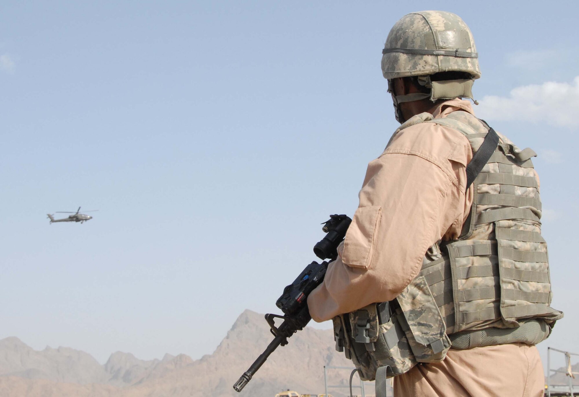 Senior Airman Kendall Wilson looks into the desert surrounding an unsecured runway April 10, 2011, in Afghanistan. Airman Kendall is a fly away security team member who travels with aircraft and prevents unauthorized access to the flightline. Airman Wilson is assigned to the 451st Expeditionary Security Forces Squadron. (U.S. Air Force photo/Tech. Sgt. Emily F. Alley)