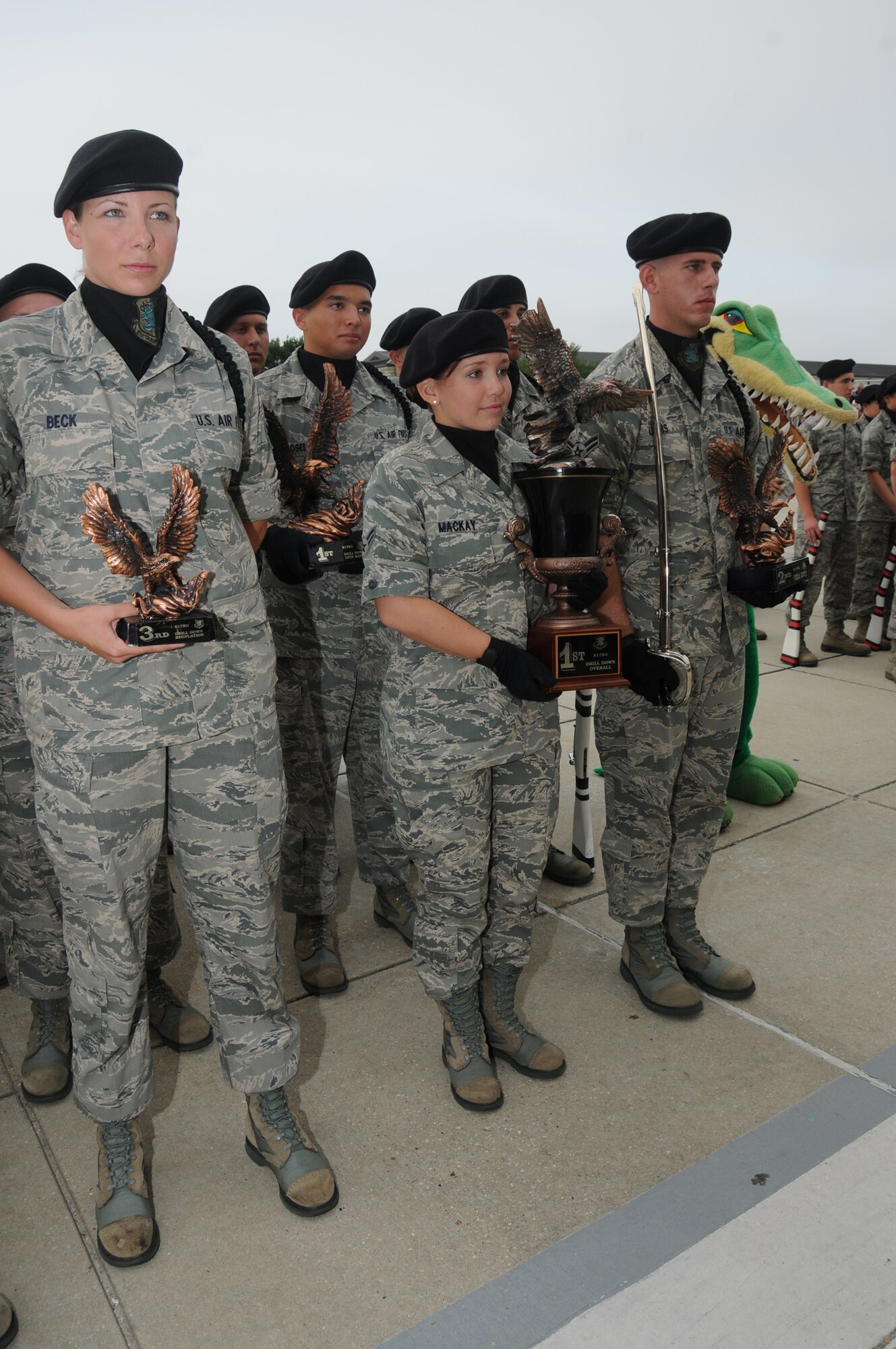 From left, Airmen Beck, Novosel, Mackay and Lewis collect trophies on behalf of the
Gators, including first place overall at Friday’s drill down competition.  (U.S. Air Force photo by Kemberly Groue)