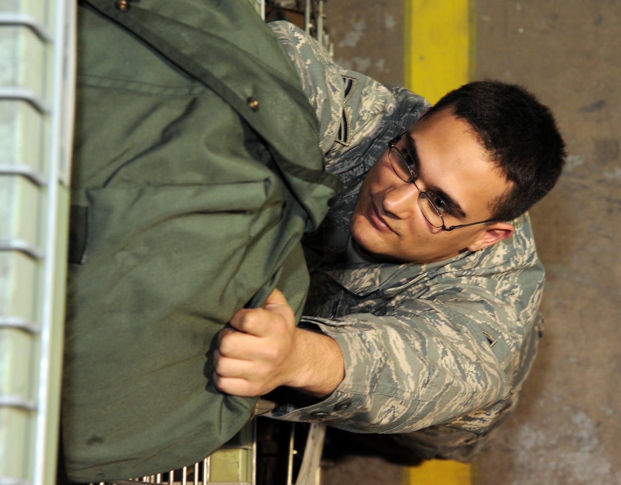 Senior Airman Antonio Burton, 22nd Logistics Readiness Squadron mobility technician, pulls a mobility bag off a shelf for inspection at the supply warehouse April 19, 2011, McConnell Air Force Base, Kan. Supply personnel examine readiness bags to ensure they contain all of the necessary equipment required for deployments. (U.S. Air Force photo/Staff Sgt. Dallas Edwards)