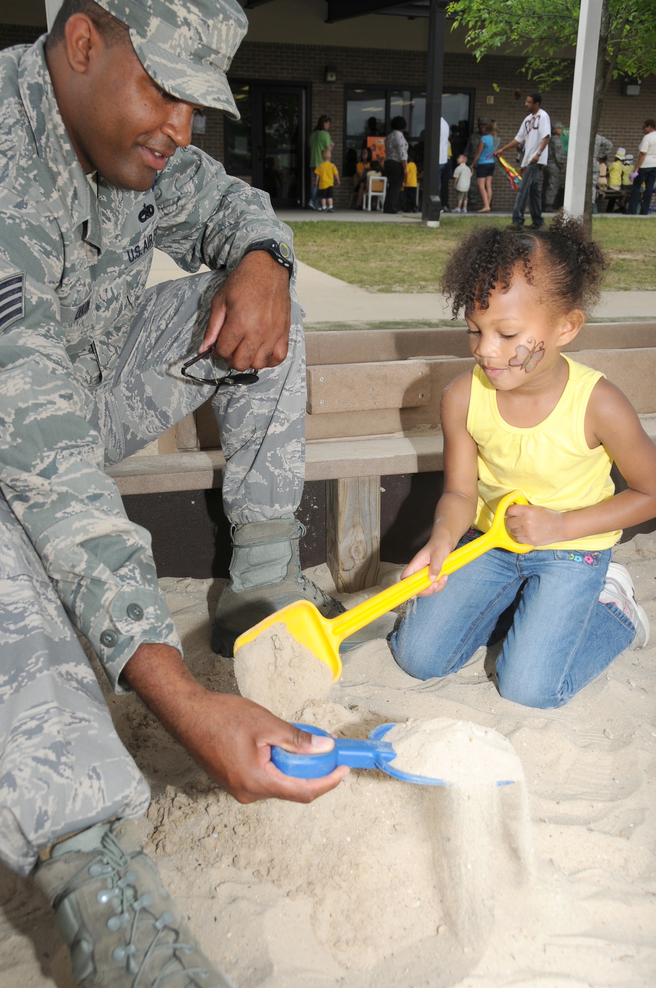 Staff Sgt. Marshall Dixon, 336th Training Squadron military training leader, and his daughter Haley, 4, begin work laying the foundation for a castle built entirely with sand. Sergeant Dixon is married to Ashley Dixon.  (U.S. Air Force photo by Kemberly Groue)