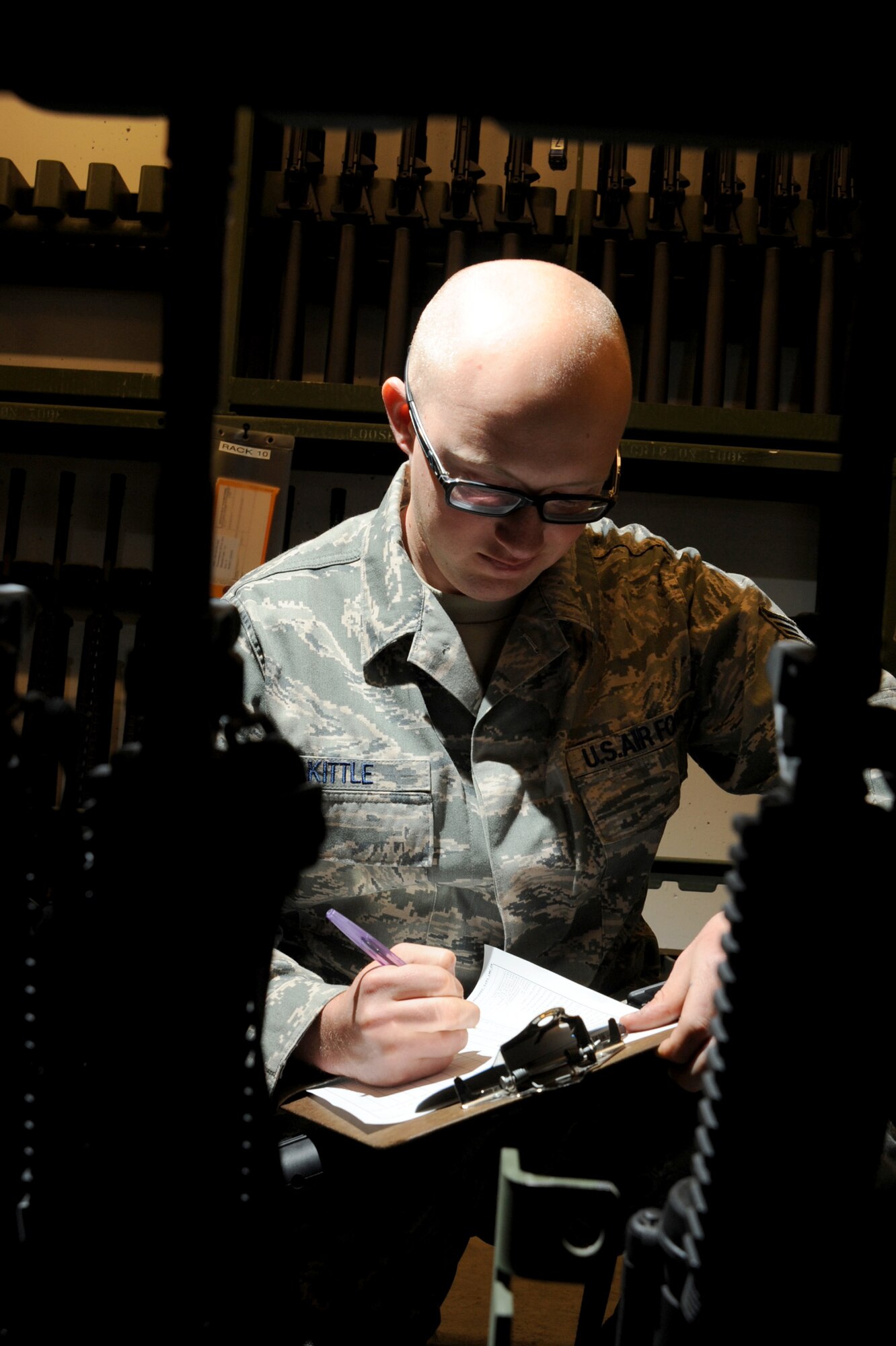 Senior Airman Cody Kittle, 22nd Logistics Readiness Squadron weapons vault technician, takes a daily inventory of M-4 Carbines at McConnell’s weapons vault April 19, 2011, McConnell Air Force Base, Kan. Weapons are cleaned and inspected before being issued to Airmen who are deploying or participating in exercises. (U.S. Air Force photo/Staff Sgt. Dallas Edwards)