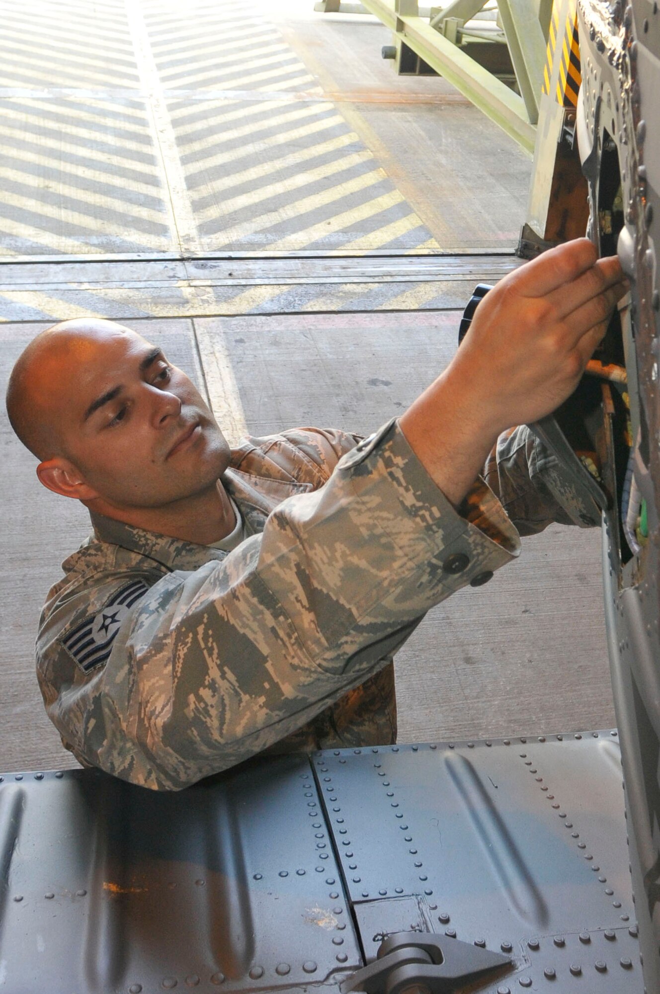 ROYAL AIR FORCE LAKENHEATH, England -- Tech. Sgt. Elias Carlon, 748th Aircraft Maintenance Squadron Electronic Warfare craftsman repairs a radar warning receiver on a HH-60 Pavehawk, April 20, 2011. Sergeant Carlon was nominated for the Liberty Spotlight, because he displays the core value of 'Excellence in All We Do' (U.S. Air Force photo/Senior Airman Eboni Reams)