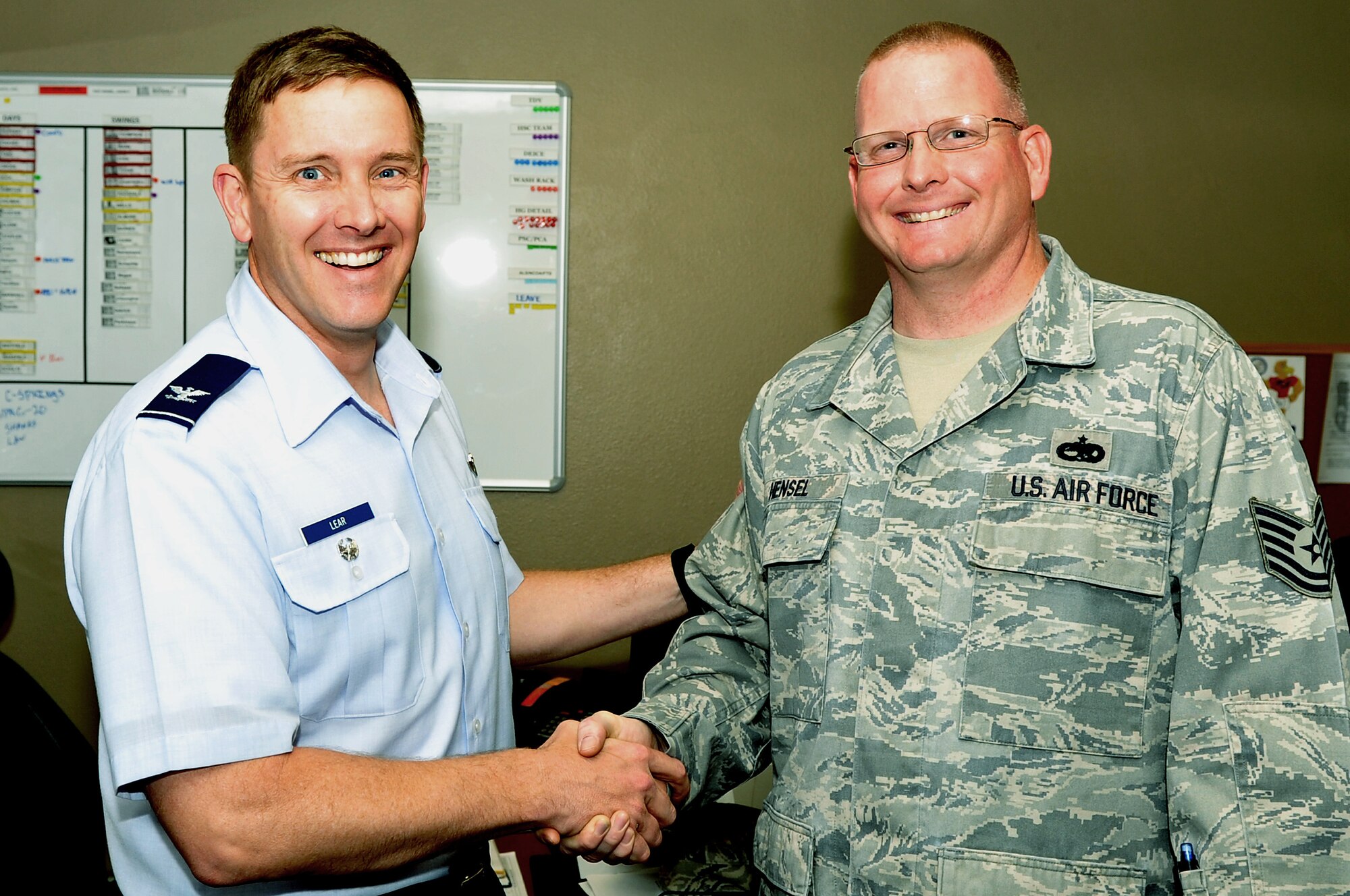 Col. Kirk Lear, 314th Airlift Wing vice commander, presents a commander’s coin to Tech. Sgt. Jason Hensel, a 314th Aircraft Maintenance Squadron assistant section chief, April 18, 2011, at Little Rock Air Force Base, Ark. Sergeant Hensel designed a weekly, future task and status tracking visual aid for the unit’s section chief offices, significantly improving the daily organization and productivity of his unit. (U.S. Air Force photo by Airman 1st Class Rusty Frank)
