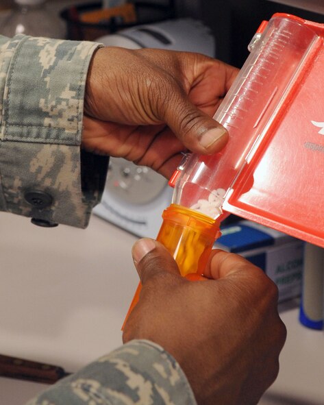 Staff Sgt. Bobby Banks, 2nd Medical Support Squadron main pharmacy NCOIC, pours medication into a bottle after carefully verifying the pill count at the base pharmacy on Barksdale Air Force Base, La., April 20. The main base pharmacy fills 23,000 prescriptions per month and service 67,000 beneficiaries. The main base pharmacy operates from 7:30 a.m. until 5:00 p.m., but closes at noon the second Thursday of each month for training. (U.S. Air Force photo/Senior Airman La?Shanette V. Garrett) (RELEASED)