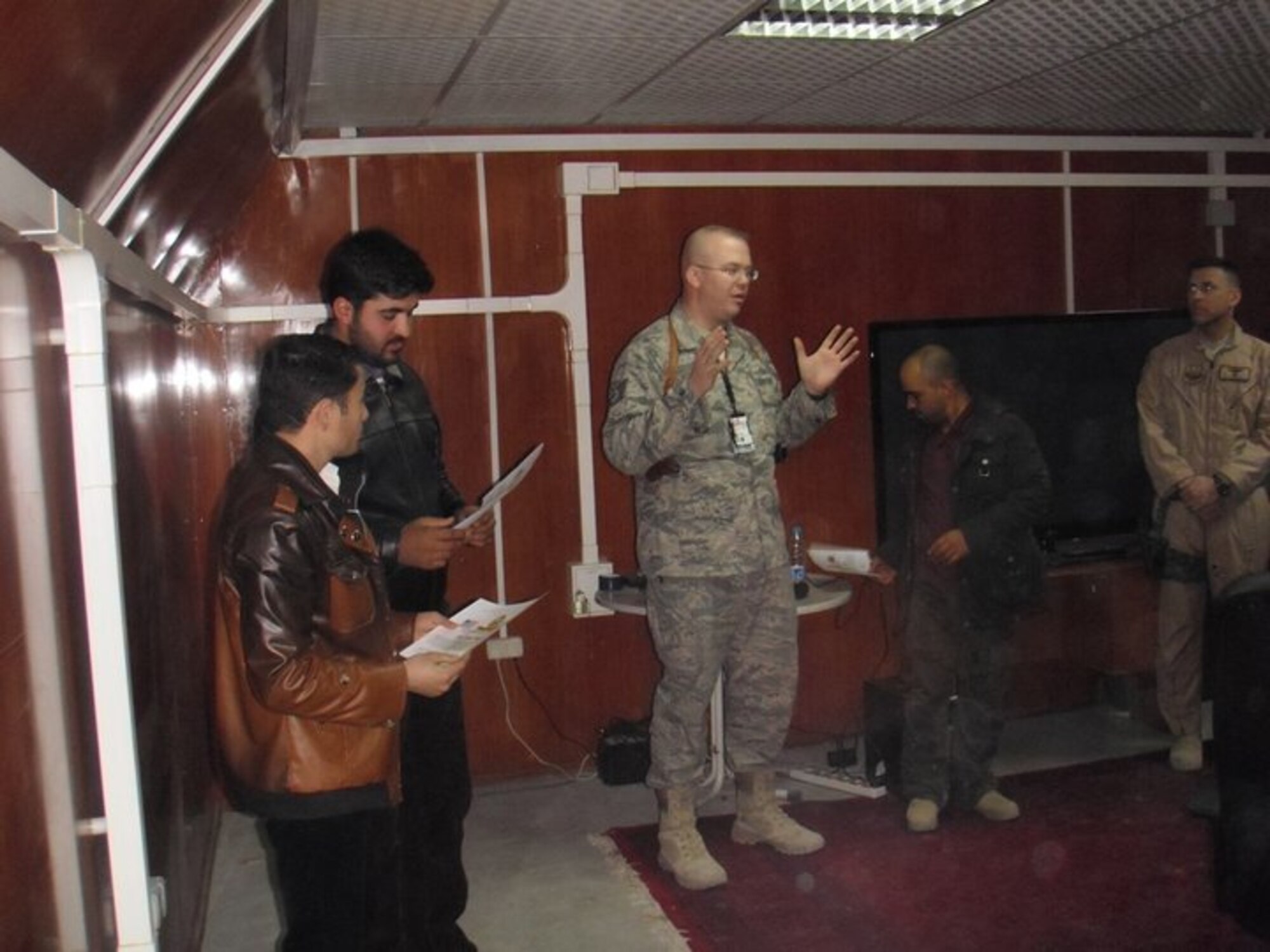 Technical Sgt. Lee Marsters, center, 43rd Operation Support Squadron, briefs Afghan air force members on classified information protection and security, and the creation and delivery of a professional military intelligence brief in support of Afghanistan’s air force flying operations in Kabul, Afghanistan.

