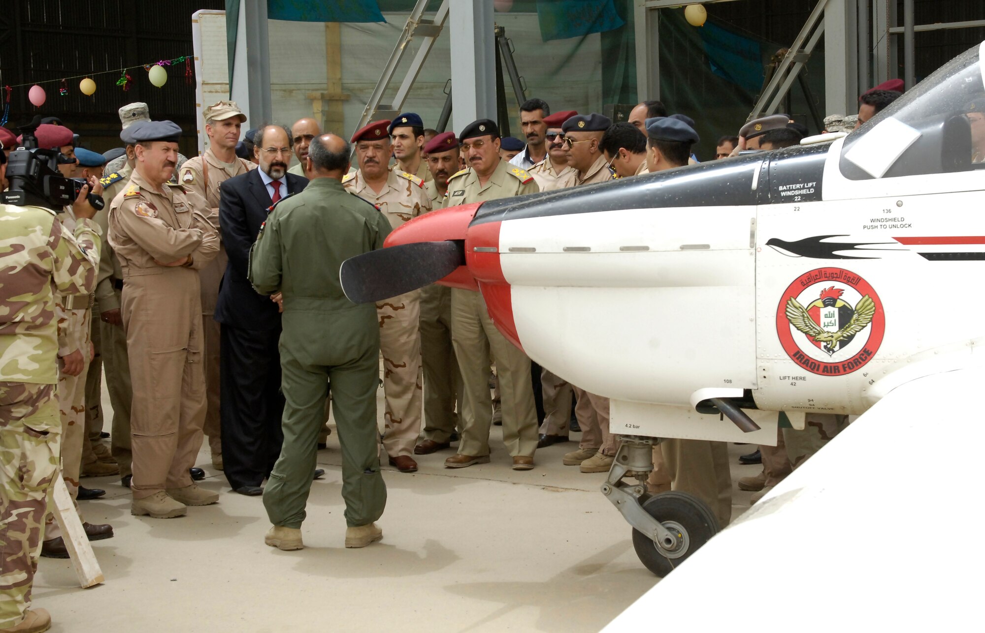 VICTORY BASE COMPLEX, Iraq – An Iraqi air force pilot explains the details of his aircraft to the Iraqi Chairman of the Defense and Security Committee of Parliament (black suit) during Iraqi air force day April 21. Senior Iraqi officials came from all over the country to celebrate the Iraqi air force’s 80th birthday. (U.S. Air Force photo by Tech. Sgt. Randy Redman)