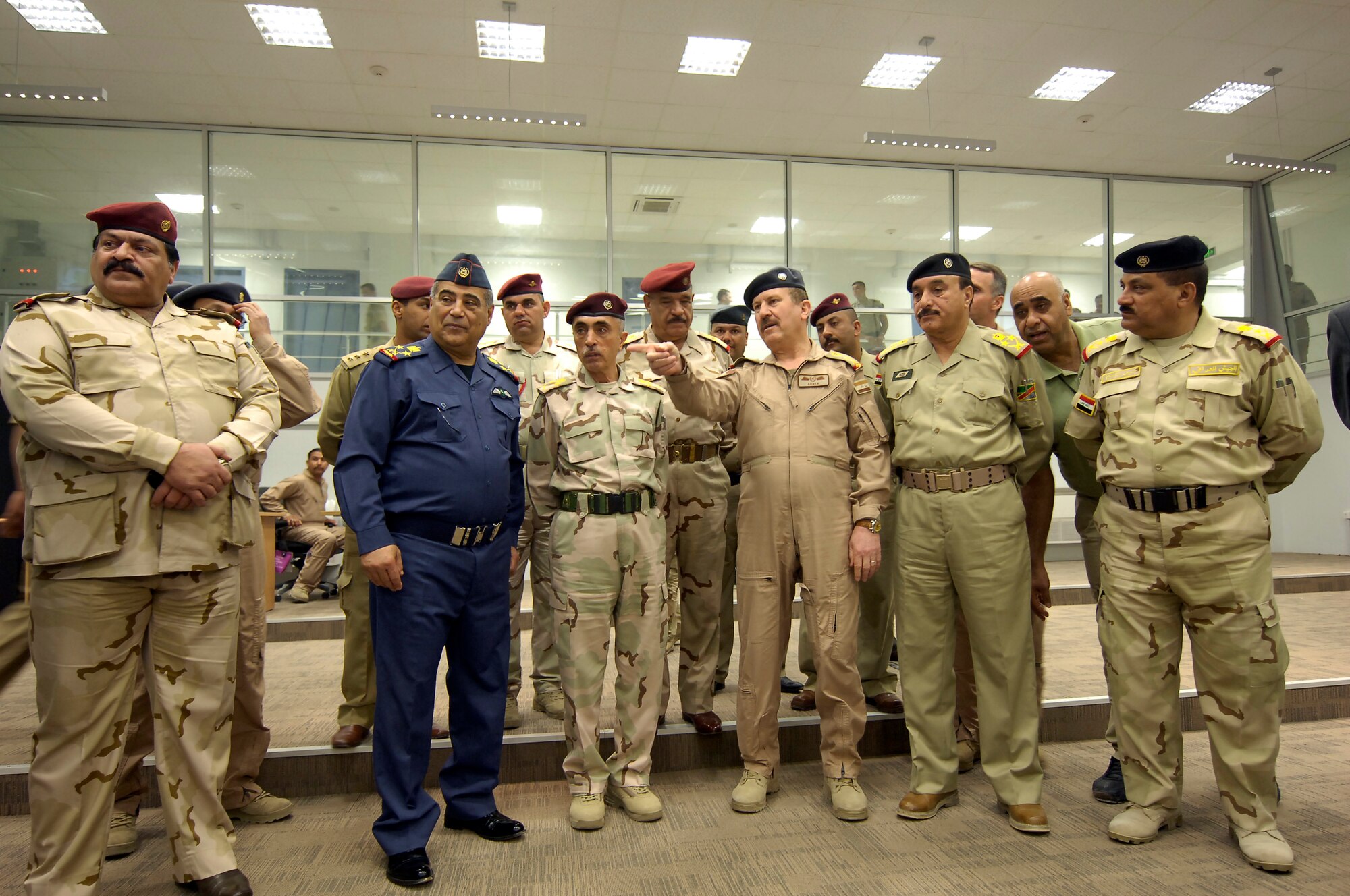 VICTORY BASE COMPLEX, Iraq – Lt. Gen. Anwar Ahmed, Iraqi air force commander, points out the highlights of the new Iraqi air operations center to senior Iraqi air force officials after a ribbon-cutting ceremony April 21. The ribbon-cutting ceremony was just one of the many events held in celebration of the Iraqi air force’s 80th birthday. (U.S. Air Force photo by Tech. Sgt. Randy Redman) 