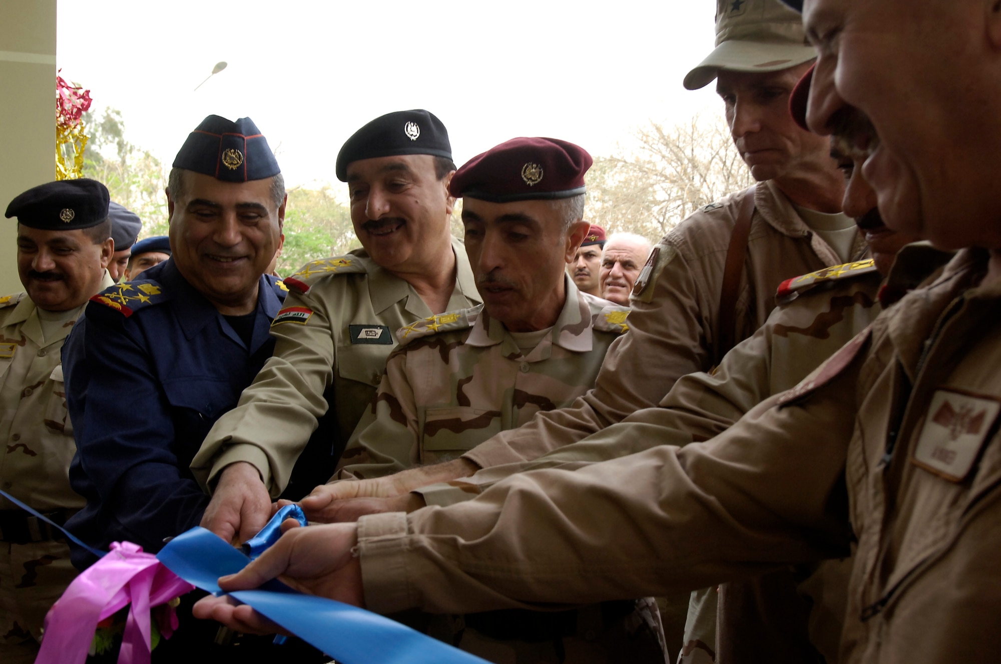 VICTORY BASE COMPLEX, Iraq – Senior Iraqi military officials along with the Iraq Training and Advisory Mission – Air director, Brig. Gen. Anthony Rock, cut the ribbon at the formal opening ceremony for the new Iraqi air operations center April 21. The ribbon-cutting ceremony was just one of the many events held in celebration of the Iraqi air force’s 80th birthday. (U.S. Air Force photo by Tech. Sgt. Randy Redman) 