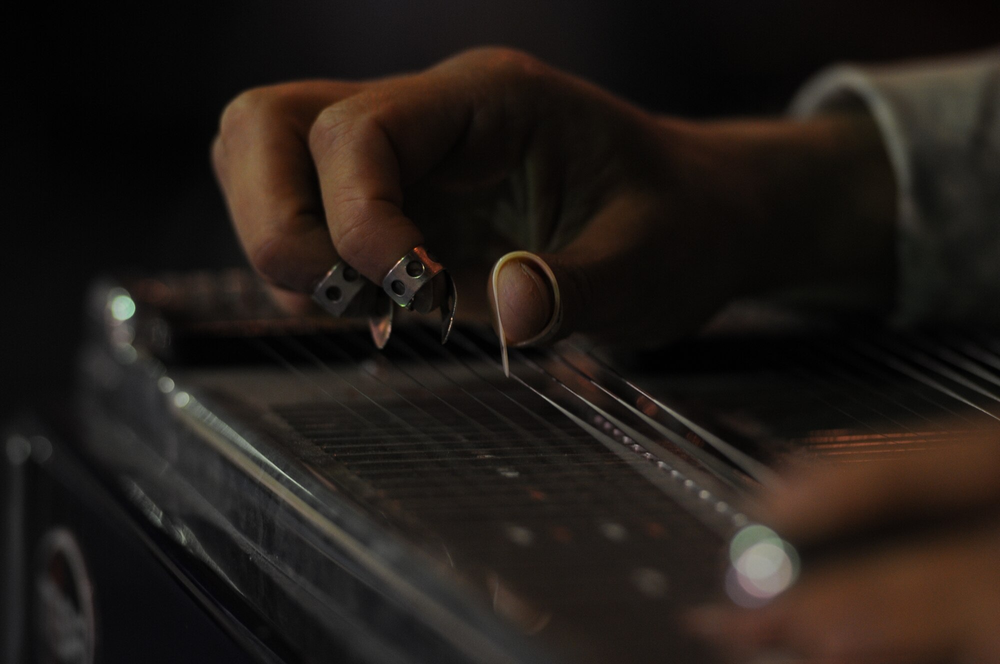 Tech. Sgt. Jeff Valentine of "Wild Blue Country" the U.S. Air Forces Central Band, plays the pedal steel guitar during a concert for Airmen of the 438th AEW at the Afghan Conference Center at Afghan Air Force Base, Kabul. Air Force photo by Tech. Sgt. Brian E. Christiansen