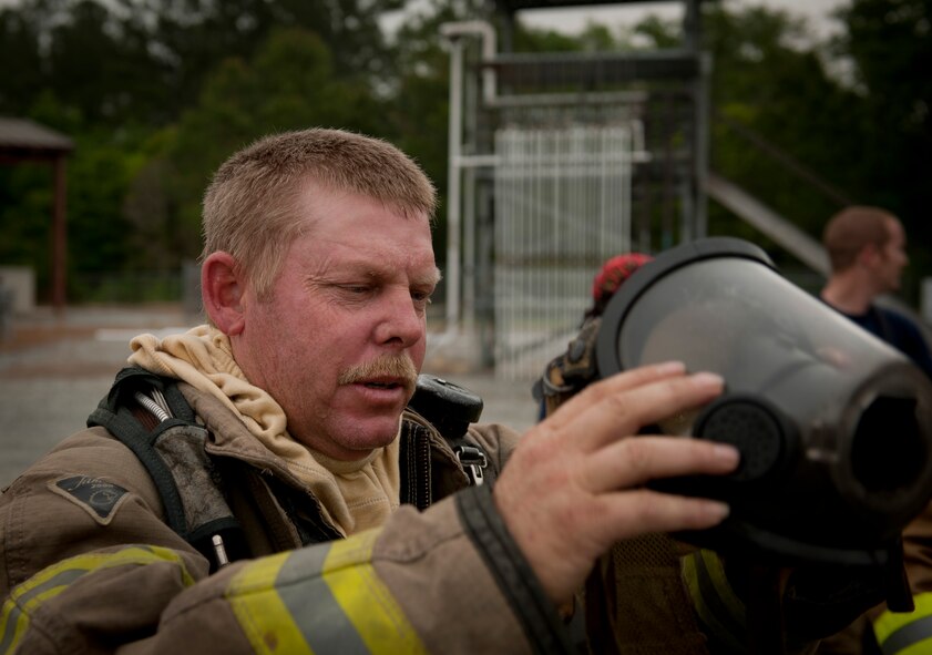 MOODY AIR FORCE BASE, Ga. -- Members of the Valdosta Fire Department put out a fire on an aircraft fire trainer wing during a training exercise at Moody Air Force Base, Ga., April 20. Teams of three were assigned and tasked with goals to extinguish the fire surrounding the downed aircraft. (U.S. Air Force photo/Airman 1st Class Joshua Green)