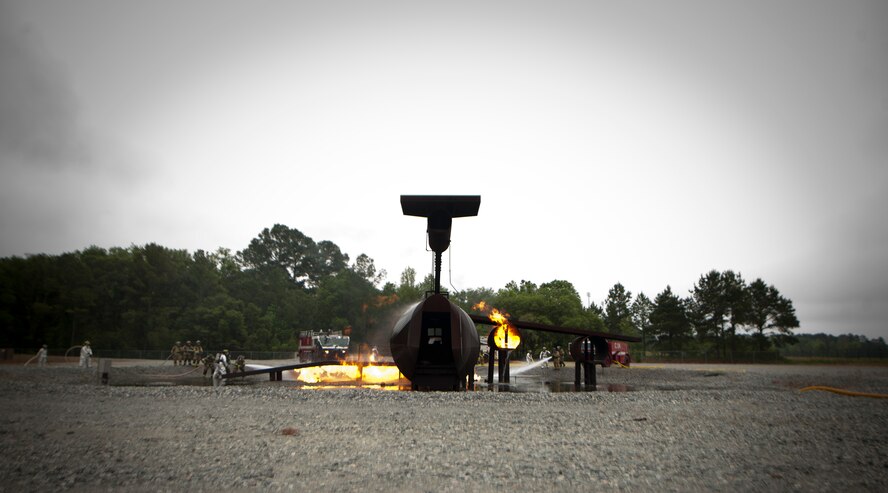 MOODY AIR FORCE BASE, Ga.-- Members of the Valdosta Fire Department attack fires on Moody’s aircraft fire trainer during a training exercise April 20. Members of the Valdosta Fire Department used teams of three to control and put out the fire surrounding the aircraft. (U.S. Air Force photo/Airman 1st Class Joshua Green)(RELEASED)
