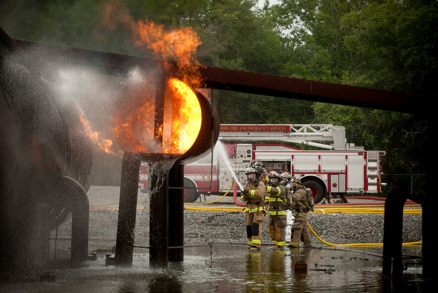 MOODY AIR FORCE BASE, Ga.-- Members of the Valdosta Fire Department put out  a fire on Moody’s aircraft fire trainer wing during a training exercise April 20. Teams of three were assigned and tasked with goals to extinguish the fire surrounding the downed aircraft. (U.S. Air Force photo/Airman 1st Class Joshua Green)(RELEASED)

