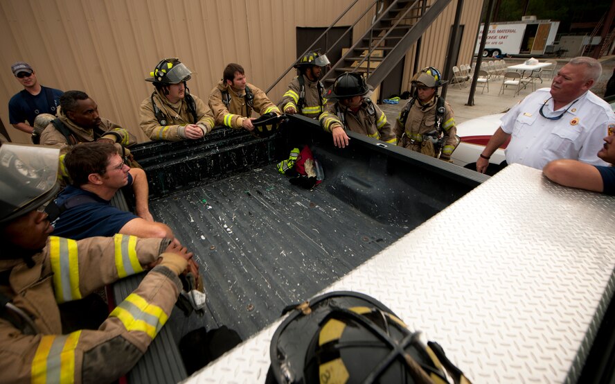 MOODY AIR FORCE BASE, Ga.-- Members from the Valdosta Fire Department gather around and discuss a  plan of action before a  training exercise April 20. The exercise scenario involved putting out a fire on a downed aircraft in teams of three or four. (U.S. Air Force photo/Airman 1st Class Joshua Green)(RELEASED)

