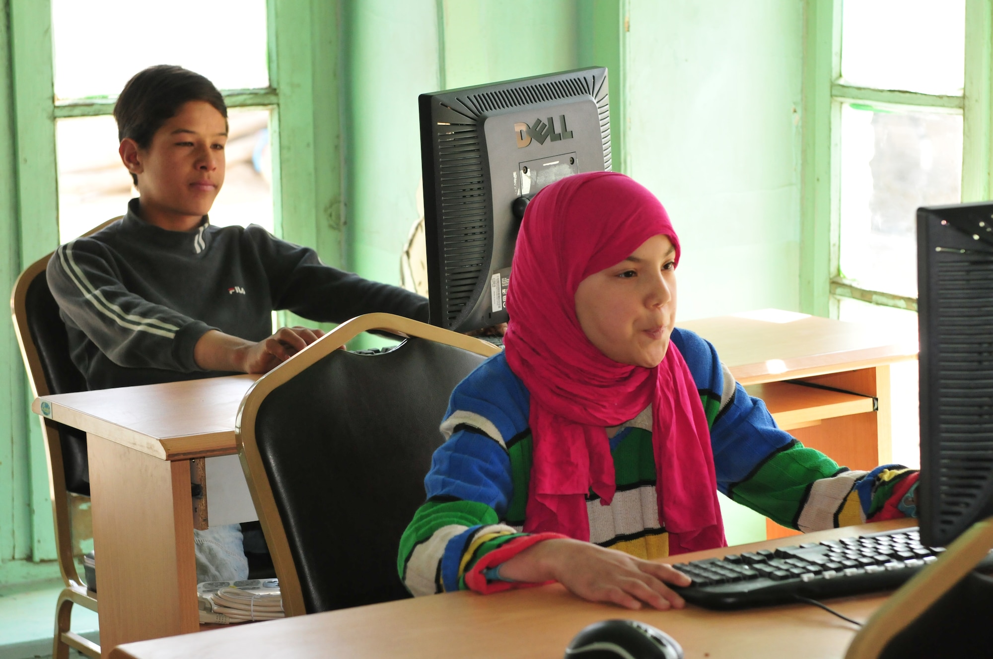 KABUL, Afghanistan -- Unidentified SOZO School students learn to use a computer. After months of coordination, computers once used in various NATO offices found their way to a school in Afghanistan. Dubbed Aladdin's Lamp, a multi-national crew from the Heavy Airlift Wing transported more than 24 computers and 130 flat screen monitors from Eindhoven, The Netherlands, to Kandahar. From there, the equipment made its way to a final destination in Kabul and were donated to SOZO, a non-profit charity organization. The computers are now in a SOZO school, where teachers educating more than 150 students. (U.S. Air Force photo/Tech. Sgt. Kevin Williams)