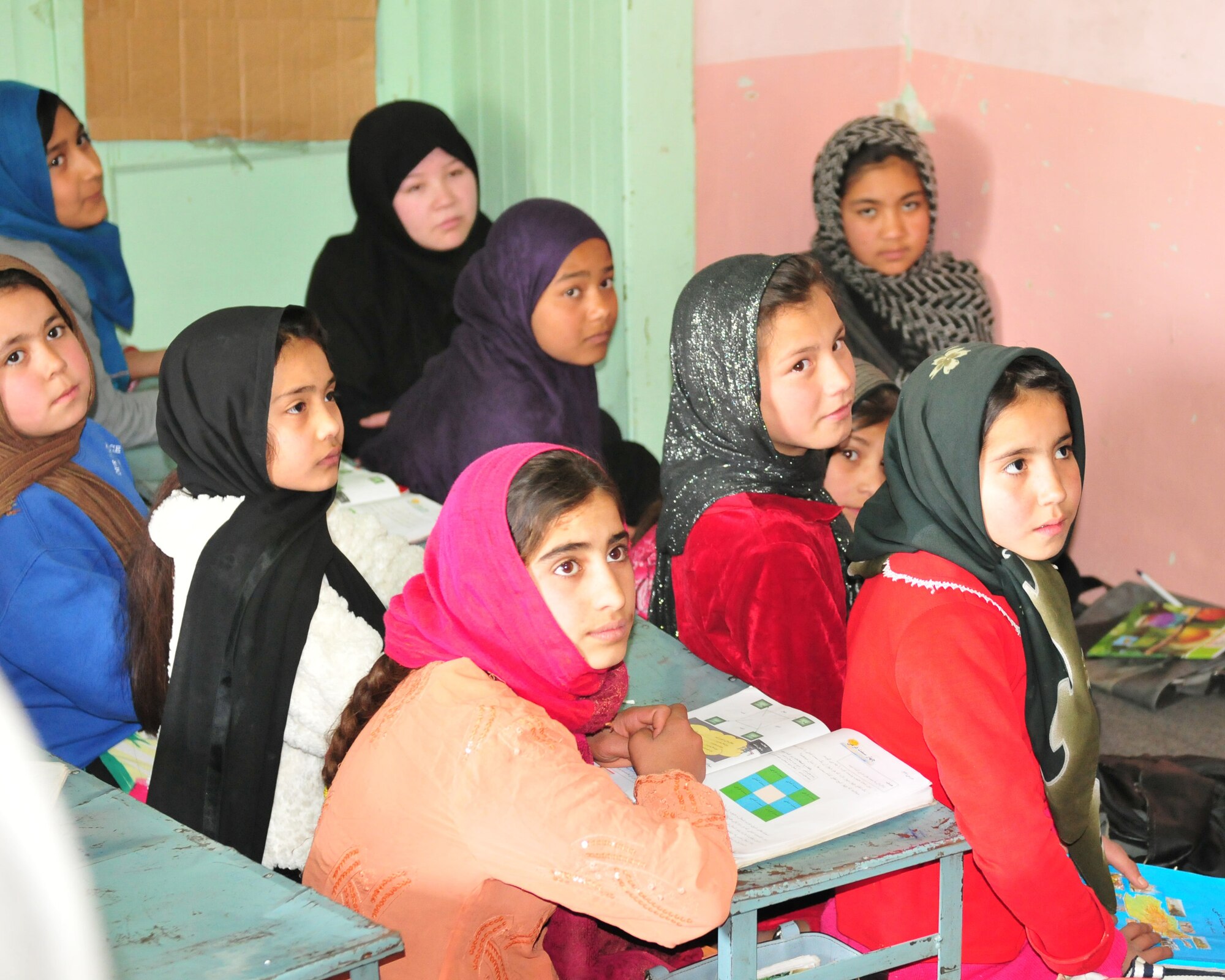 KABUL, Afghanistan -- Students from the SOZO School in Kabul wait for class to begin. After months of coordination, computers once used in various NATO offices found their way to a school in Afghanistan. Dubbed Aladdin's Lamp, a multi-national crew from the Heavy Airlift Wing transported more than 24 computers and 130 flat screen monitors from Eindhoven, The Netherlands, to Kandahar. From there, the equipment made its way to a final destination in Kabul and were donated to SOZO, a non-profit charity organization. The computers are now in a SOZO school, where teachers educating more than 150 students. (U.S. Air Force photo/Tech. Sgt. Kevin Williams)