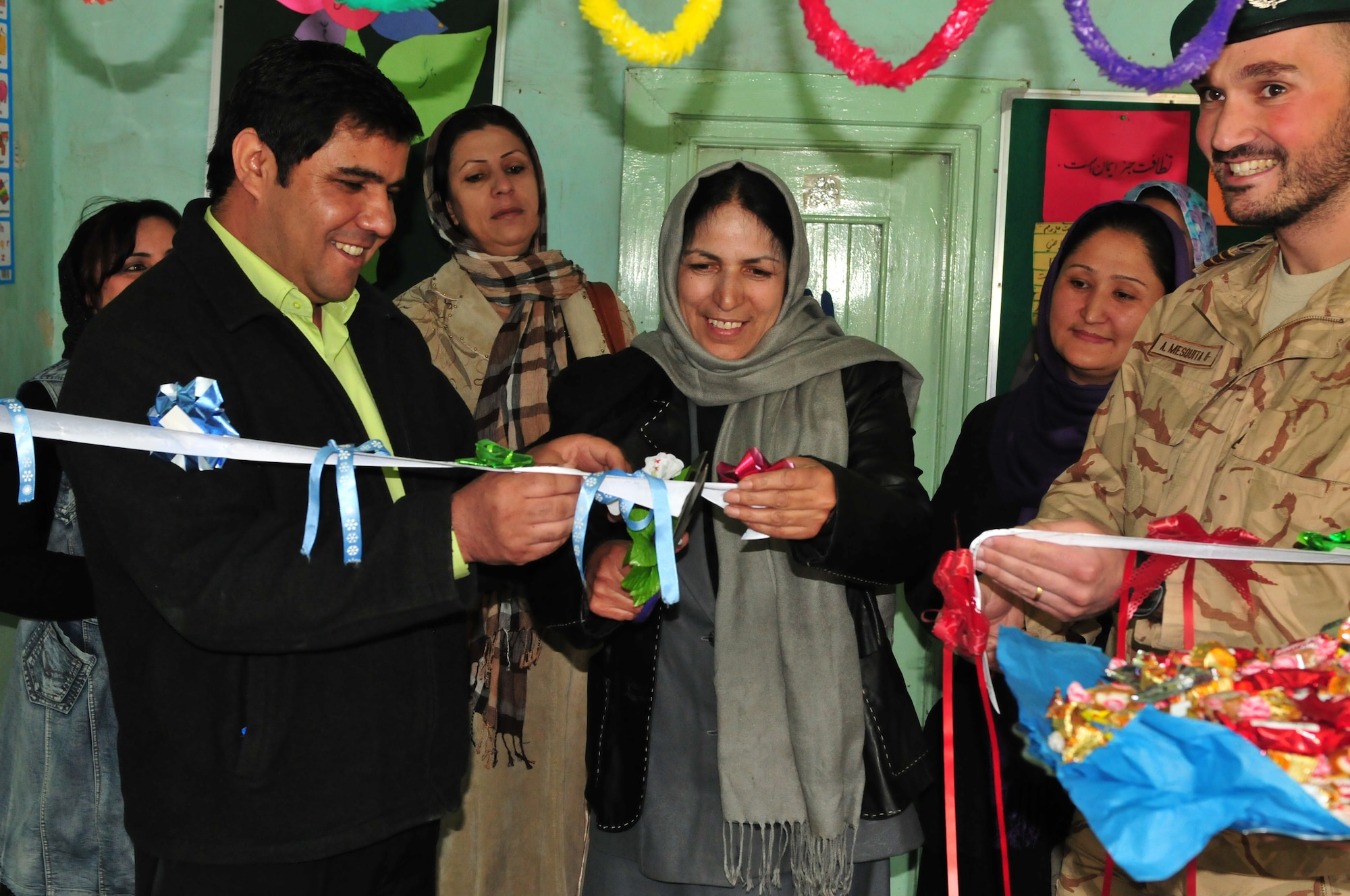 KABUL, Afghanistan -- Members of SOZO, a non-profit charity organization, cut a ribbon to symbolize the opening of computers to their students. After months of coordination, computers once used in various NATO offices found their way to a school in Afghanistan. Dubbed Aladdin's Lamp, a multi-national crew from the Heavy Airlift Wing transported more than 24 computers and 130 flat screen monitors from Eindhoven, The Netherlands, to Kandahar. From there, the equipment made its way to a final destination in Kabul and were donated to SOZO, a non-profit charity organization. The computers are now in a SOZO School, where teachers are educating more than 150 students. (U.S. Air Force photo/Tech. Sgt. Kevin Williams)
