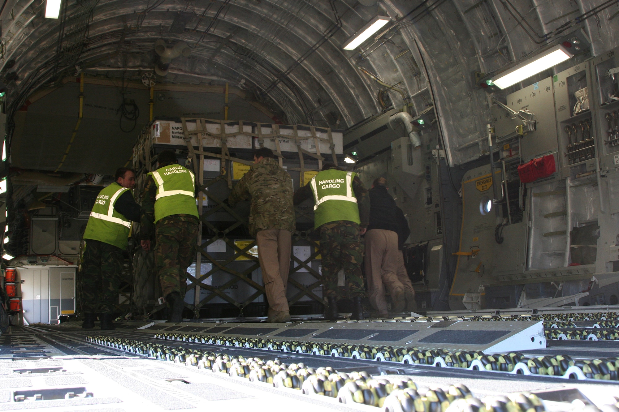 EINDHOVEN, The Netherlands -- Computer equipment is loaded on to a Heavy Airlift Wing C-17. After months of coordination, computers once used in various NATO offices found their way to a school in Afghanistan. Dubbed Aladdin's Lamp, a multi-national crew from the HAW transported more than 24 computers and 130 flat screen monitors from Eindhoven, The Netherlands, to Kandahar. From there, the equipment made its way to a final destination in Kabul and were donated to SOZO, a non-profit charity organization. The computers are now in a SOZO School, where teachers are educating more than 150 students. (Courtesy photo)