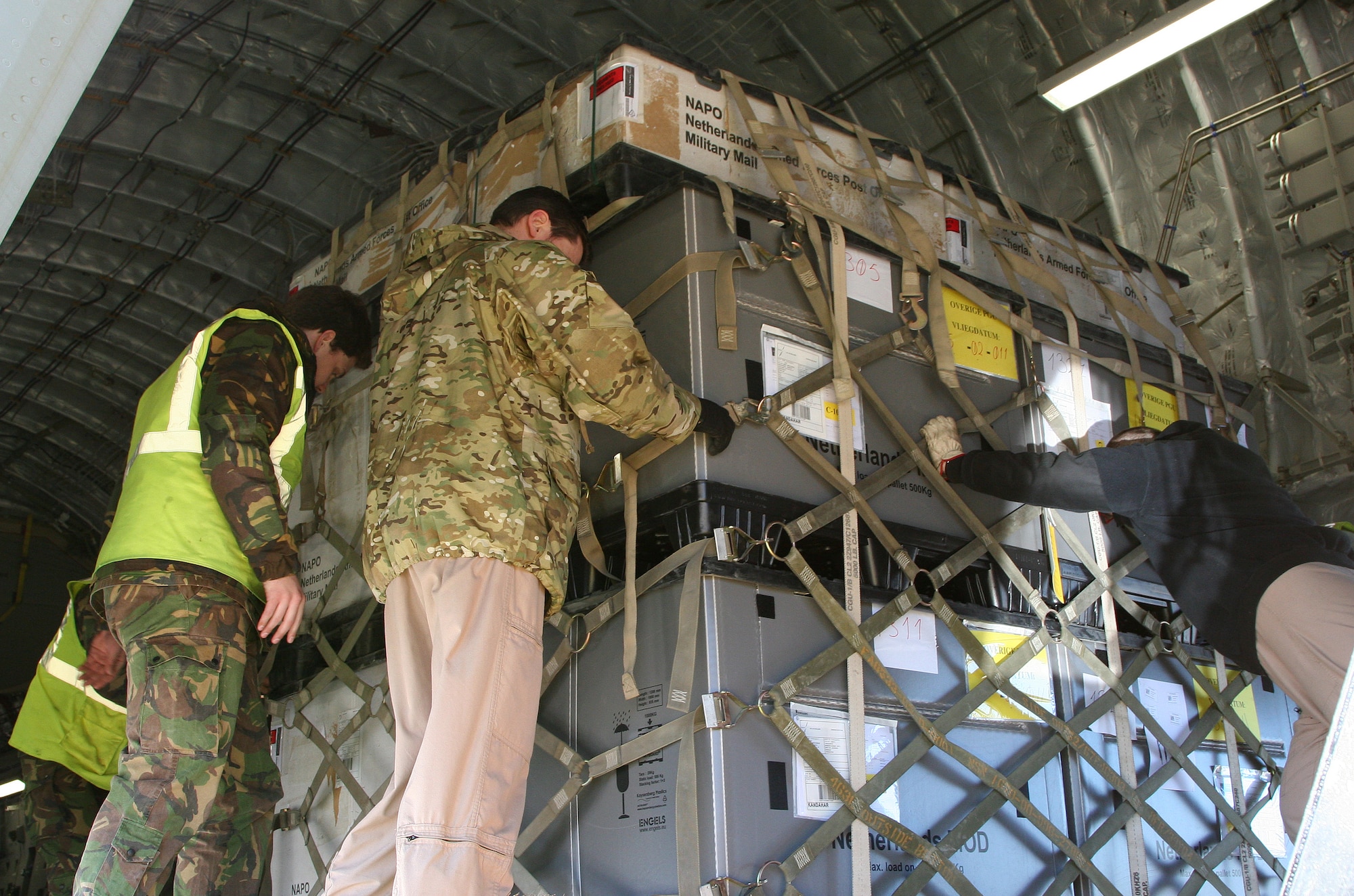 EINDHOVEN, The Netherlands -- Computer equipment is loaded on to a Heavy Airlift Wing C-17. After months of coordination, computers once used in various NATO offices found their way to a school in Afghanistan. Dubbed Aladdin's Lamp, a multi-national crew from the HAW transported more than 24 computers and 130 flat screen monitors from Eindhoven, The Netherlands, to Kandahar. From there, the equipment made its way to a final destination in Kabul and were donated to SOZO, a non-profit charity organization. The computers are now in a SOZO School, where teachers are educating more than 150 students. (Courtesy photo)