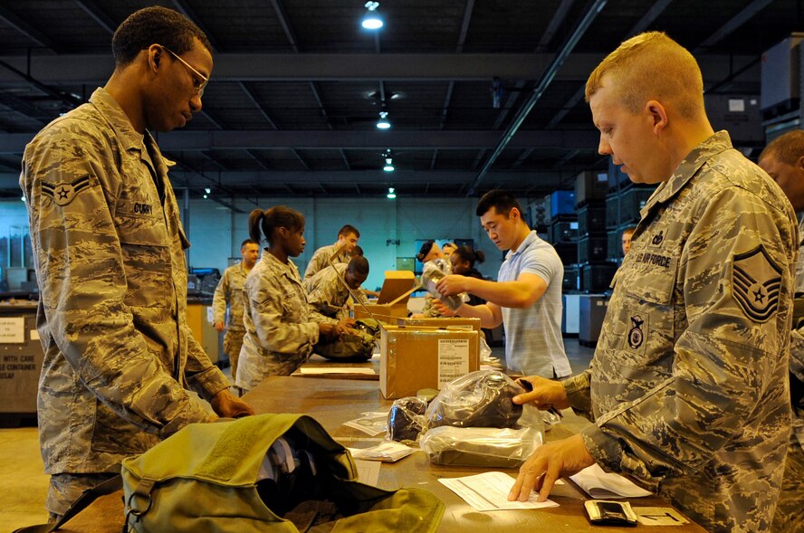 Airman 1st Class Cameron Curry, 2nd Logistics Readiness Squadron mobility apprentice, assists Master Sgt. Albert Bernicker, 2nd Security Forces Squadron, with issuing the new M50 gas mask on Barksdale Air Force Base, La., April 18. The 2 LRS Individual Protective Equipment section issued more than 400 masks to the 2 SFS. (U.S. Air Force photo/Staff Sgt. John Gordinier)