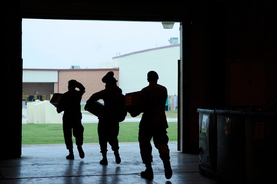 Three Airmen with the 2nd Security Forces Squadron leave the 2nd Logistics Readiness Squadron mobility section after receiving their new M50 gas masks on Barksdale Air Force Base, La., April 18. The 2 LRS Individual Protective Equipment Section issued more than 400 masks to the 2 SFS. (U.S. Air Force photo/Staff Sgt. John Gordinier)