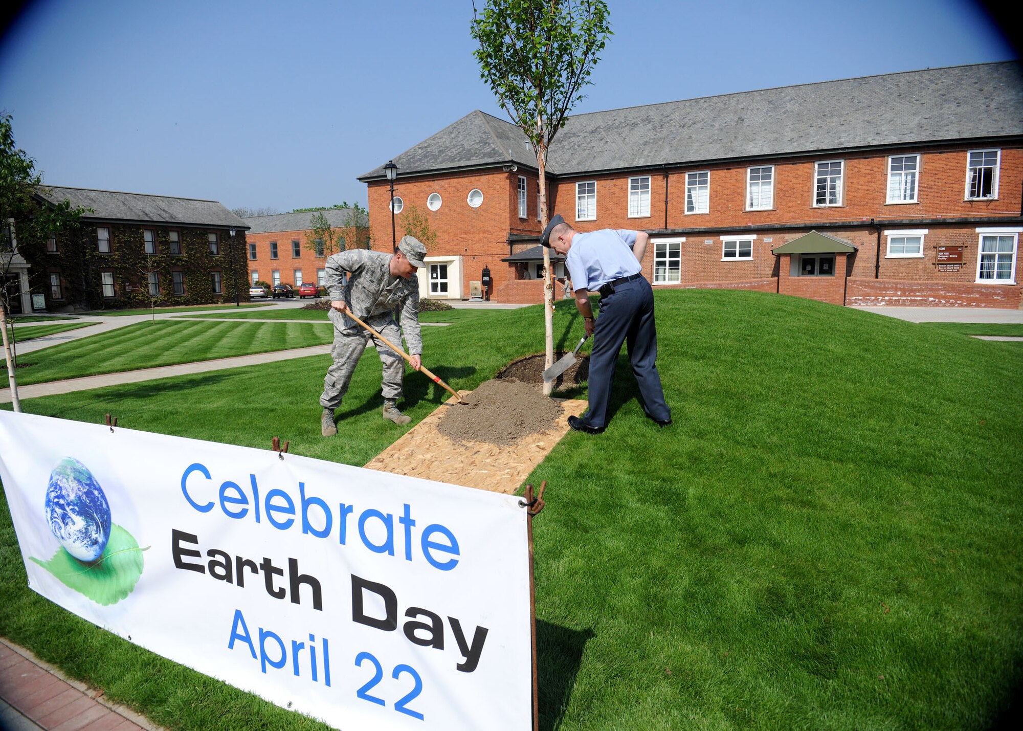 RAF MILDENHALL, England -- Col. David Doe, 100th Mission Support Group commander, and RAF Squ. Ldr. Rick Fryer, RAF Mildenhall station commander, plant the final tree in the newly reconstructed Washington Square to celebrate Earth Week April 20, 2011. (U.S. Air Force photo/Staff Sgt. Jerry Fleshman)