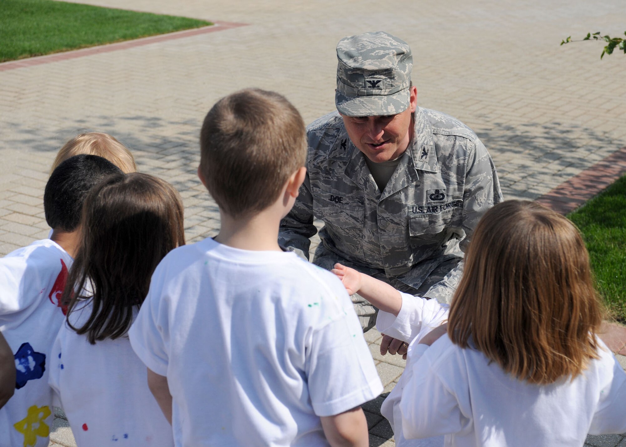 RAF MILDENHALL, England -- Col. David Doe, 100th Mission Support Group commander, speaks with children from the child development center during the grand reopening/tree planting event at the newly reconstructed Washington Square green area April 20, 2011. (U.S. Air Force photo/Staff Sgt. Jerry Fleshman)