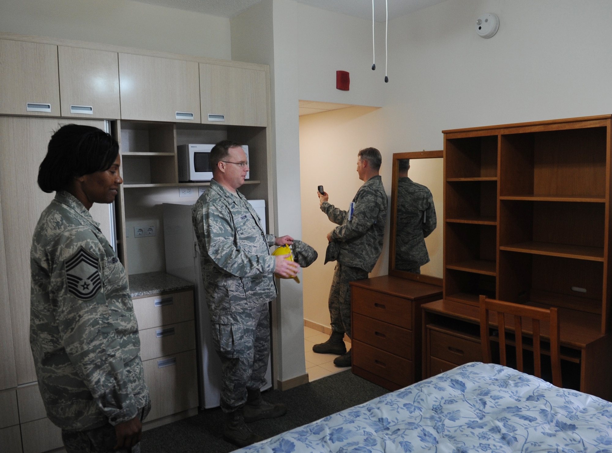 Col. Eric Beene, the 39th Air Base Wing commander, Chief Master Sgt. Priscilla Bolding, from the 39th Force Support Squadron, and Lt. Col. Bryan Wolford, the 39th Operations Squadron commander, examine one of the rooms in a recently renovated dormitory April 6, 2011, at Incirlik Air Base, Turkey. The dorm was originally constructed in 1963 and has had several renovations to keep up with the quality of life standards set by the Air Force. (U.S. Air Force photo by Airman 1st Class Clayton Lenhardt)