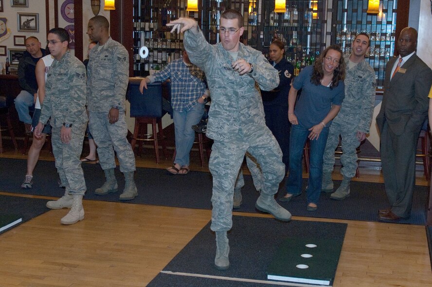 HANSCOM AIR FORCE BASE, Mass. – Airman 1st Class Caleb Kearby, 66th Force Support Squadron, throws a washer during the Washers Tournament at the Minuteman Club April 14. The team from the 319th Recruiting Squadron won the tournament. (U.S. Air Force photo by Rick Berry)