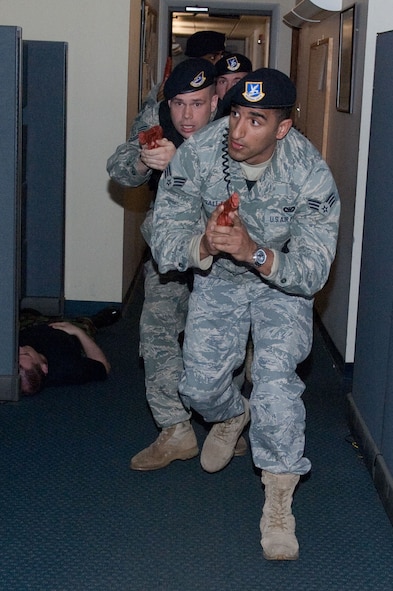 HANSCOM AIR FORCE BASE, Mass. – Senior Airman Elias Musallam and Tech Sgt. Wayne Griggs enter Building 1810 during the active shooter Base Readiness Exercise scenario April 14. Several exercises are planned for the next few months to prepare personnel for an impending Operational Readiness Inspection in the fall. (U.S. Air Force photo by Rick Berry)