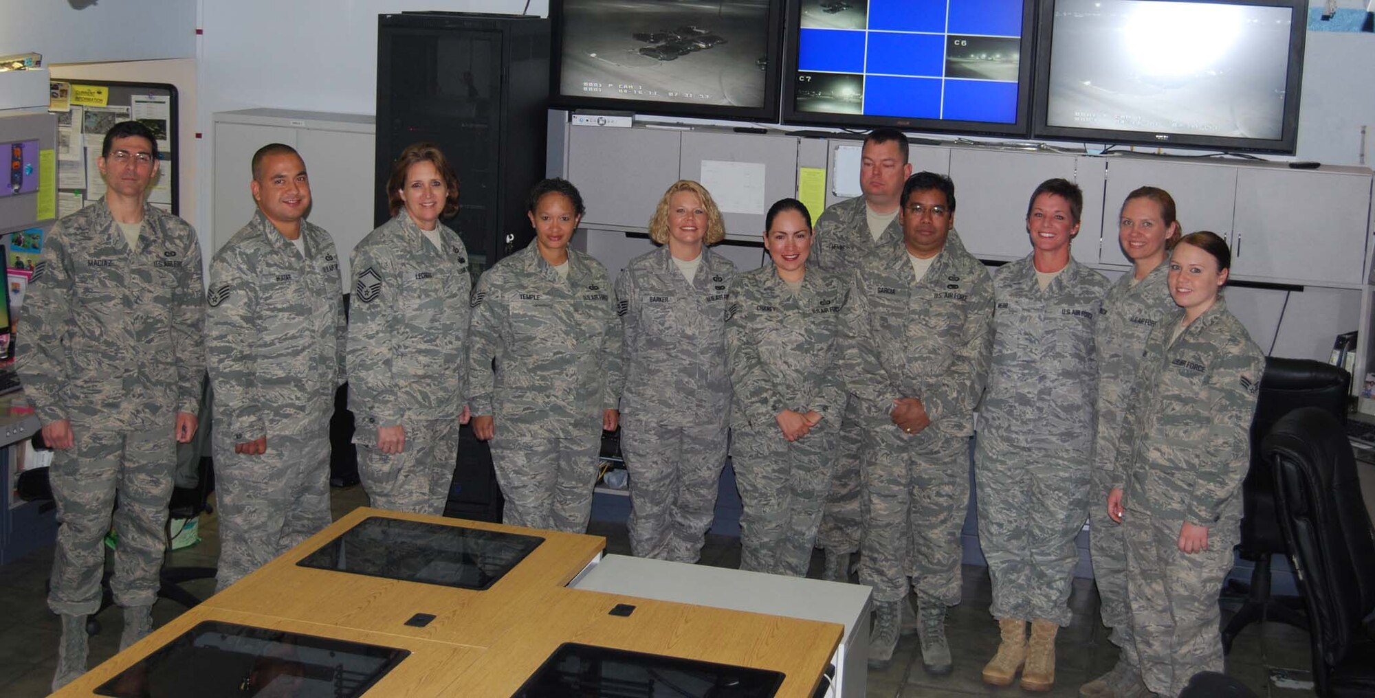 Members of the 433rd Airlift Wing command post stand in the wing's nerve center for information and operations. The Alamo Wing command post earned the 4th Air Force Small Conventional Command Post of the Year award and is in competition for the Air Force Reserve Command award. (U.S. Air photo/ Senior Airman Viola M. Hernandez)