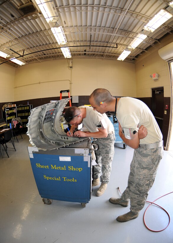 Staff Sgt. Jeff King and Staff Sgt.Nathan Poudrier from the Structural Maintenance shop 104th Fighter Wing Westfield Massachusetts, measure for a patch on a cracked gun panel at Tyndall Air Force Base in Florida on April 20, 2011.This gun panel was found cracked after on an F-15 aircraft after an exercise flight. While they are deployed to Tyndall Air Force Base in Florida, they are participating in the Weapons System Evaluation Program (WSEP).  (U.S. Air Force Photo by: Technical Sergeant, Melanie J. Casineau)
