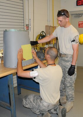 Staff Sgt. Jeff King and Staff Sgt.Nathan Poudrier from the Structural Maintenance shop 104th Fighter Wing Westfield Massachusetts, measure for a patch on the cracked gun panel at Tyndall Air Force Base in Fla. on April 20, 2011.This gun panel was found cracked after on an F-15 aircraft after an exercise flight. While they are deployed to Tyndall Air Force Base in Florida, they are participating in the Weapons System Evaluation Program (WSEP).  (U.S. Air Force Photo by: Technical Sergeant, Melanie J. Casineau)