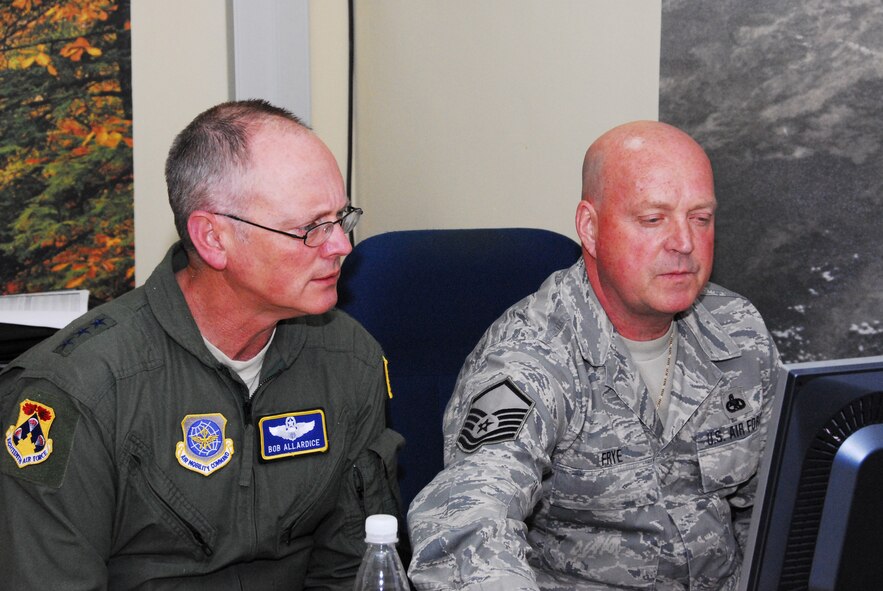 WESTERN EUROPE (April 15, 2011) -- Master Sgt. Leslie Frye, 126th Air Refueling Wing, Illinois Air National Guard, explains the maintenance status report of the 313th Air Expeditionary Wing to Lt. Gen. Robert Allardice, commander of 18th Air Force. The 313th AEW supports Operation Unified Protector, a NATO-led mission in Libya to protect civilian and civilian-populated areas under threat of attack. The 313th AEW provides aerial refueling to U.S. and coalition aircraft with KC-135 Stratotankers and KC-10 Extenders. (U.S. Air Force photo by Tech. Sgt. Stacy Gault/Released)