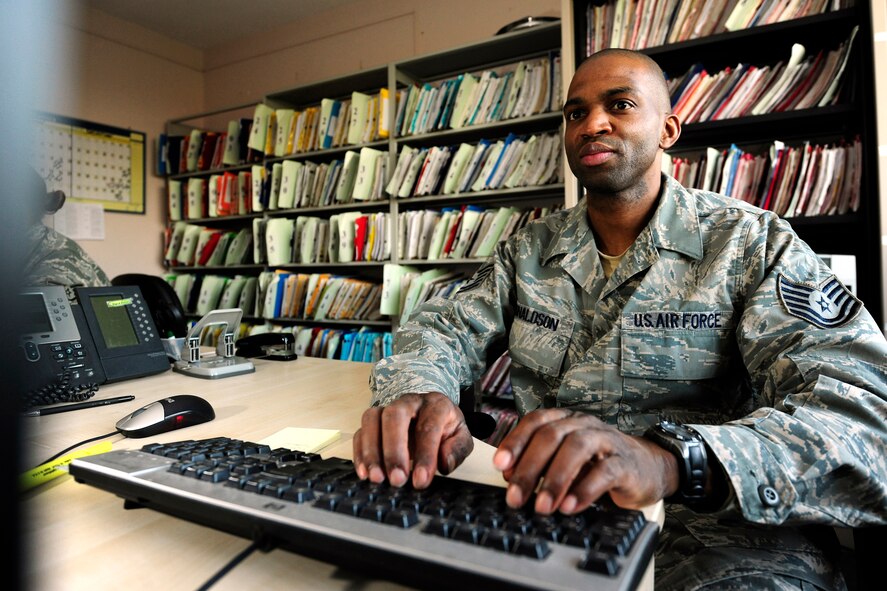 Tech. Sgt. Alton Donaldson, NCOIC Medical Administration, 422nd Air Base Group, digitizes medical files at RAF Croughton. (U.S. Air Force photo by Tech. Sgt. John Barton)