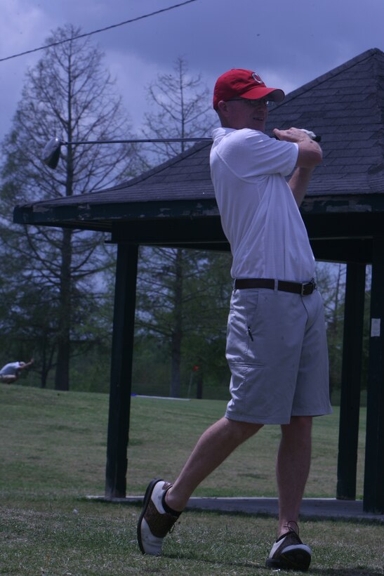 Sgt. Maj. Chris Bloebaum, the sergeant major for Headquaters Battalion MarForRes, swings his club at the Bayou Barriere Golf Club, April 21.  The golf tournament was held as a fundraiser for the Marine Corps Birthday Ball.