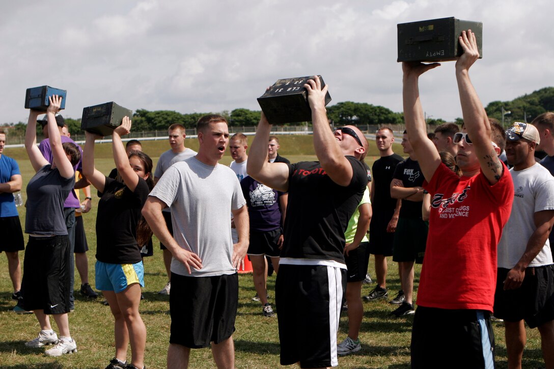 Marines with Combat Logistics Battalion 31, 31st Marine Expeditionary Unit, compete against each other during an ammunition can lift contest, April 22. The contest was part of a CLB 31 field meet, which included a tire flipping contest, egg toss, tug of war, and many other events that build unit camaraderie.