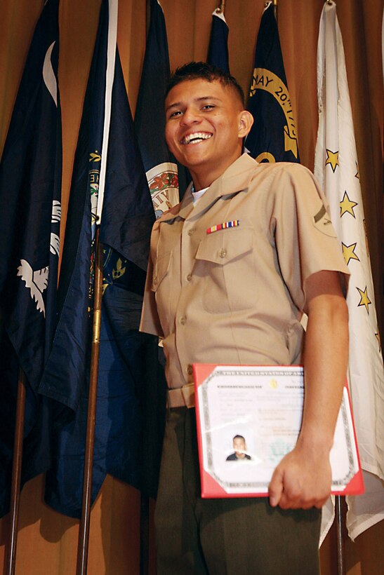 Lance Cpl. Oscar Archaga, a promotions and awards clerk with the 31st Marine Expeditionary Unit, stands proud after his naturalization ceremony at the Camp Foster theater April 22.