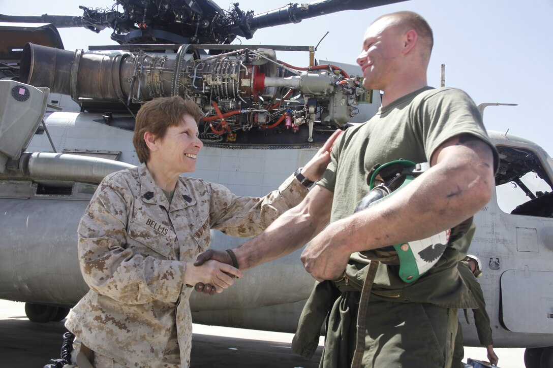 2nd Marine Aircraft Wing Sgt. Maj. Susan M. Bellis speaks with Cpl. Casey West on the runway at Camp Bastion, Afghanistan, April 22. Bellis visited Marine aviation squadrons deployed to Afghanistan in order to assess the needs of Marines and observe daily operations. West, a Richmond, Va., native, is an airframes mechanic with Marine Heavy Helicopter Squadron 461 deployed out of Marine Corps Air Station New River, N.C.