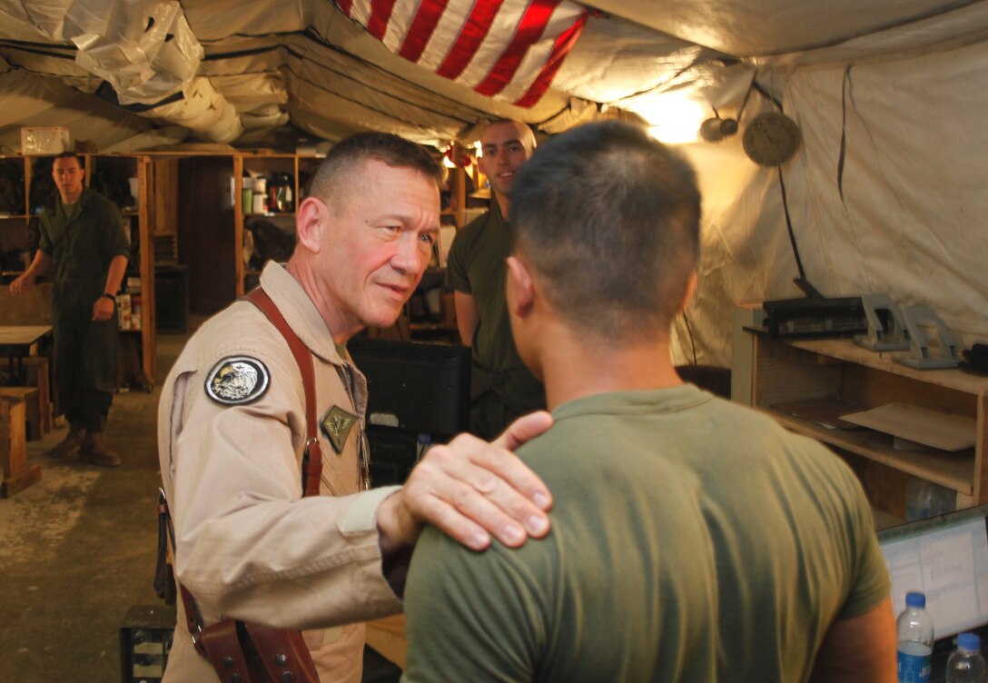 Maj. Gen. Jon M. Davis, 2nd Marine Aircraft Wing commanding general, speaks with Houston-native Sgt. David Nguyen inside the Marine Heavy Helicopter Squadron 461 airframes office at Camp Bastion, Afghanistan, April 22. Davis visited Marine aviation squadrons deployed to Afghanistan in order to assess the needs of Marines and observe daily operations. Nguyen is an airframes mechanic with HMH-461 deployed out of Marine Corps Air Station New River, N.C.